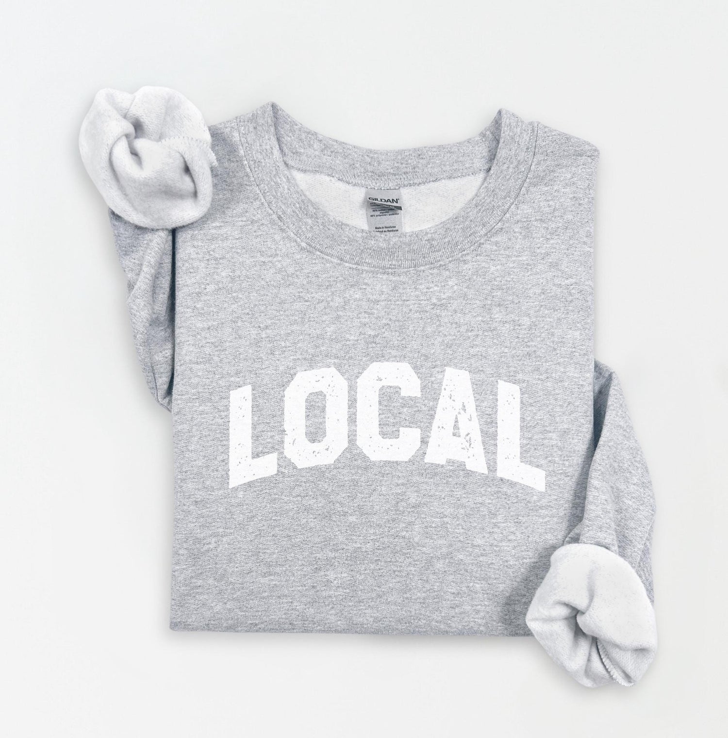 a gray sweatshirt with the word local printed on it
